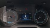 Car instrument cluster showing a central screen with a seatbelt-not-fastened warning and READY indicator at 05:15 AM in an EV dashboard.