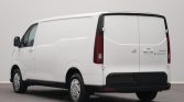 Rear three-quarter view of a white panel van with closed rear doors in a studio setting.