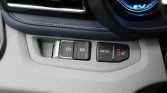 Close-up of a car's lower dashboard controls: electronic parking brake, auto hold, MODE, and a lit 3-bar seat heater indicator.