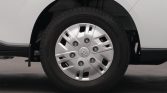 Close-up of a car wheel with a silver hubcap and Toyota center emblem, tire shown on a white vehicle.