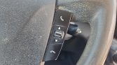 Steering wheel control panel with phone answer/end buttons and a small center rocker switch
