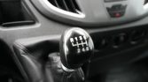 Manual six-speed gear shift knob in a car, showing R and gears 1–6 on the pattern.