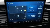 Car infotainment touchscreen displaying a navigation map and blue controls on the dashboard surface, with time 11:40 visible at top left.
