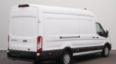 Rear and right-side view of a white Ford Transit cargo van with rear doors closed, parked on a dark surface