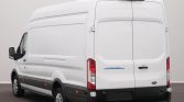 White Ford Transit cargo van seen from the rear-left, with high roof and closed rear doors.