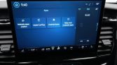 Infotainment touchscreen showing app shortcuts: Mobile apps search, Apple CarPlay, Android Auto, Help for mobile apps; FM radio 92.60.