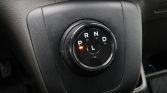 Rotary gear selector in a car with an orange indicator showing Park (P).