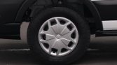 Close-up of a car wheel with a silver hubcap and rugged tire