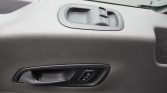Interior car door panel featuring a power window switch cluster and a separate door lock button edge panel.