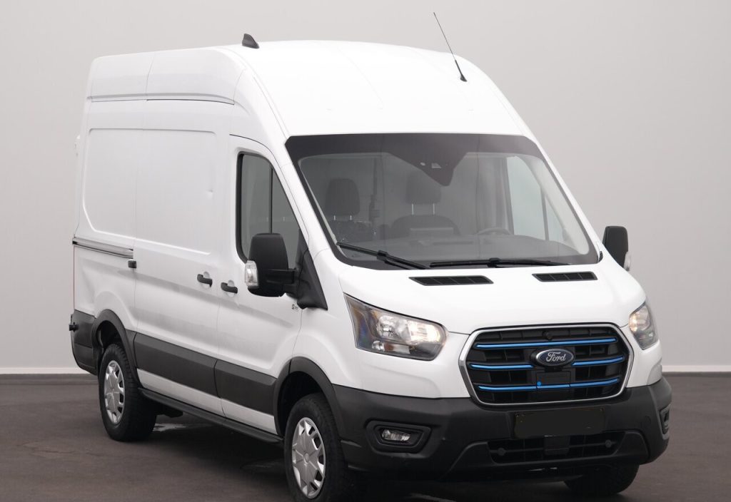 White Ford cargo van with a high roof, front grille, and black bumper, shown in a neutral studio setting.
