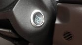 Close-up of a car's push-button ignition labeled 'POWER START STOP' with a chrome ring around it.