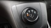 Close-up of a car's rotary gear selector with the P position lit in orange