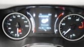 Dashboard cluster with left speedometer (0–170 km/h), right tachometer (0–50 x100 rpm), and central digital display showing settings message; parking brake light illuminated on left.