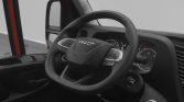 Interior view of a truck cabin focusing on the steering wheel and dashboard with the Iveco logo visible