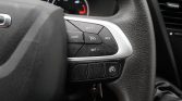 Close-up of steering wheel controls with cruise control buttons: CANC, SET+, SET-, RES and a central cruise icon.