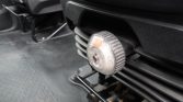 Close-up of a chrome numbered seat adjustment dial on a car seat, used to change the backrest angle.