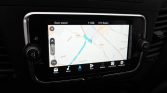Infotainment screen showing a GPS navigation map with a blue route line and current position marker in a car dashboard