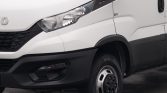 White cargo van front-left quarter with black bumper and wheel visible, showing headlight and side panel details (industrial vehicle)