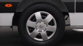 Close-up of a car wheel with a silver alloy rim and Renault center cap, black tire visible as the vehicle sits on pavement