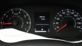 Car instrument cluster showing odometer 48,057 km and trip/readout 8.2 km with speedometer and tachometer visible.