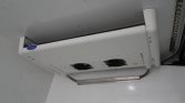 Ceiling-mounted Carrier refrigeration unit with two cooling fans and control panel on the side.