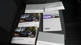 Set of Renault Master manuals and brochures on a car seat, including Media-NAV Evolution booklets.