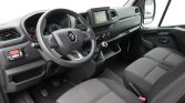 Interior of a Renault van showing the steering wheel, dashboard with a touchscreen, gear shifter, and front seats