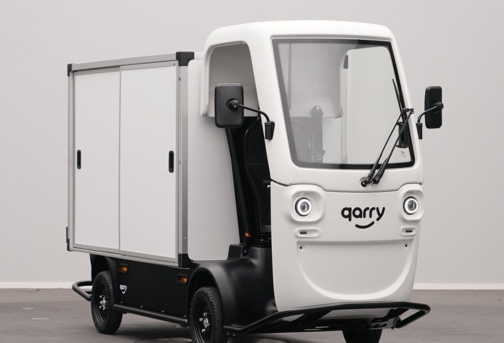 Small white autonomous delivery vehicle with a boxed cargo compartment and 'garry' branding on the front cab.