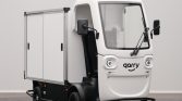 Small white autonomous delivery vehicle with a boxed cargo compartment and 'garry' branding on the front cab.