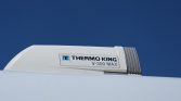 Thermo King V-300 Max refrigeration unit mounted on a white trailer against a blue sky