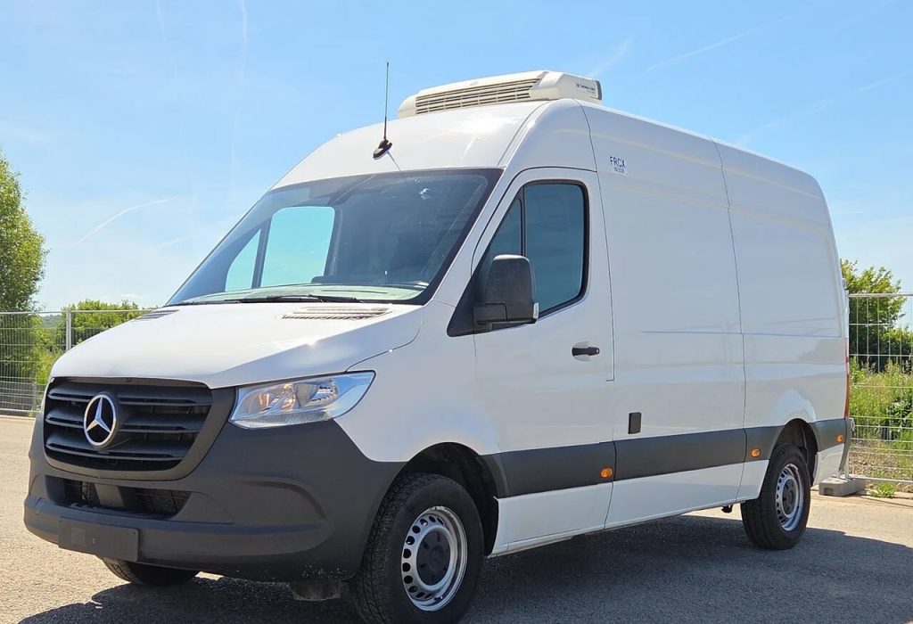 Front three-quarter view of a white Mercedes-Benz cargo van with a rooftop refrigeration unit.