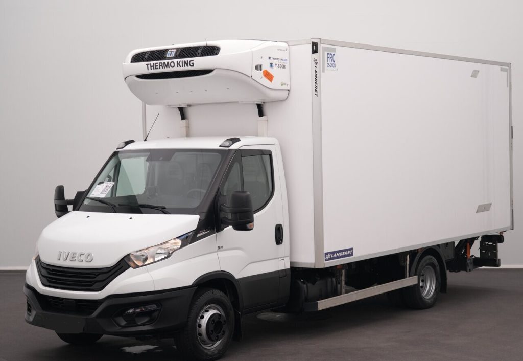 White Iveco refrigerated box truck with Thermo King unit mounted on the cab-top, in a studio setting