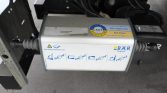 Close-up of a Bär Cargolift cargo lift control box mounted under a truck, with safety/usage diagrams and stickers visible