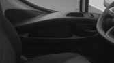 Right-hand drive car interior view showing steering wheel on the right, front passenger door, and front seat area