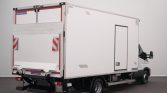 White refrigerated box truck with rear liftgate and closed doors, parked indoors with a clean gray background.