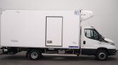 Side view of a white refrigerated box truck with a Lamberet branding on the lower rear of the cargo box, cab visible on the right and a cooling unit on top front.
