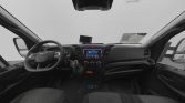 Driver's cockpit of a van with steering wheel, central touchscreen, and climate controls.