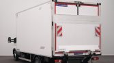 Rear view of a white box truck with a mounted tail lift and red safety stripes, branded Lamberet/Lamberet.