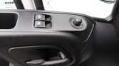 Driver-side door panel with two power window switches and a circular mirror adjustment knob nearby