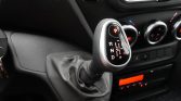 Automatic gear selector in car interior showing P, R, N, D with plus/minus_shift symbols on glossy panel.