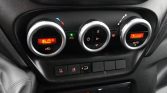 Climate control panel in a car: three round dials with a digital display showing 16.0°C on the left, green A/C indicator, and an Auto mode on the right.