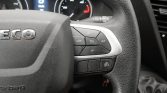 Close-up of a car steering wheel with cruise control buttons (SET+, SET-, CANCEL, RES) on the right and an