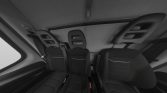 Rear seating area of a car with headrests and visible seat belts, viewed from the back of the cabin.