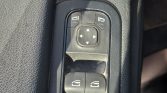 Driver-side car window/mirror control panel: four-button mirror adjust pad above two window switches on a black plastic console