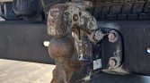 Rusty trailer hitch ball attached to a dirty bumper, ready to tow a trailer