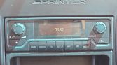 Car stereo dashboard with a digital clock reading 06:32 and labeled buttons (Radio, Media, Tel, Setup) beneath a central display.