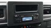 Car dashboard stereo with keypad and digital display showing AM-1 and 1413 kHz