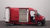 Red delivery van with side door open, showing insulated cargo area and driver’s seat inside.