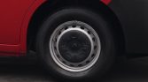 Close-up of a car wheel on a red vehicle, showing a steel rim and black tire with a Renault-style hubcap center