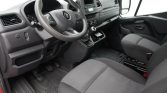 Driver's cockpit of a Renault van: steering wheel, gear lever, and dashboard controls visible in front of the driver seat.